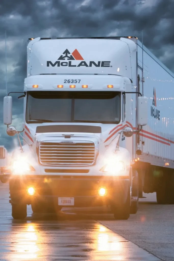 McLane truck driving under stormy skies
