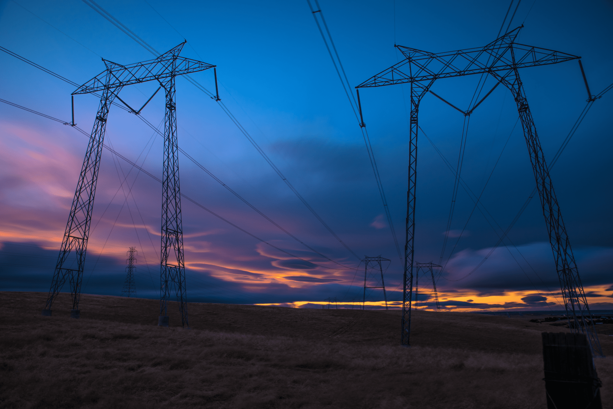 Power lines at sunset with colorful sky