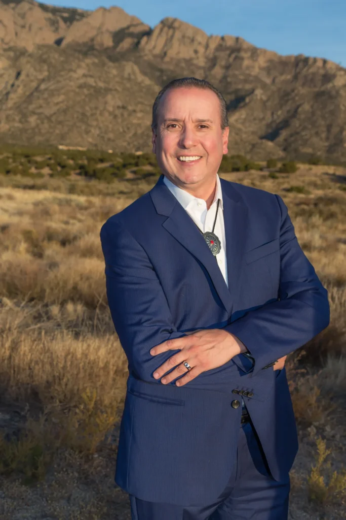 Smiling man standing outdoors with mountains